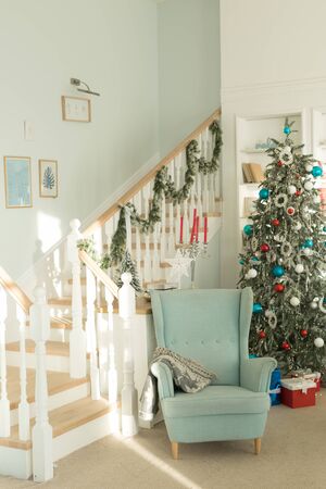 Blue chair near the Christmas tree, Christmas room interiorの写真素材