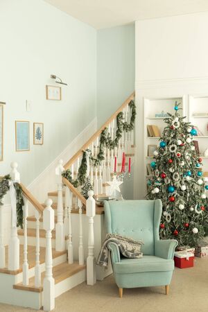 Blue chair near the Christmas tree, Christmas room interiorの写真素材