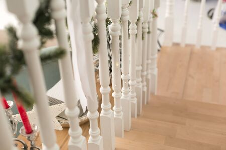 Staircase with wooden railing in the house with Christmas interiorの写真素材