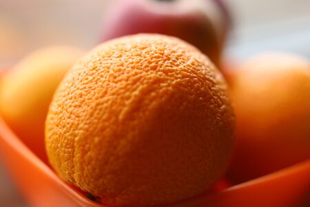 Fresh fruit is in a plate on the windowsill. Apples bananas and oranges.Soft focus. Backgrounds