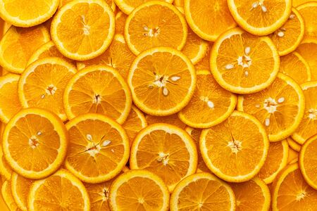 Bright orange background with slices of juicy oranges. Orange in the section. Orange-abstract fruit background, natural vitamins. Backgrounds and texturesの写真素材