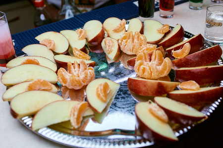 a plate of fruit on a table in a restaurantの写真素材