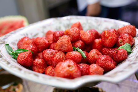 juicy strawberries on a plate of served tableの写真素材
