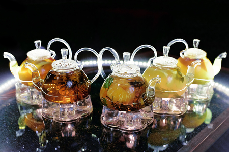 Glass teapots with tea on the table in a cafeの写真素材