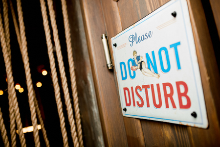 Close-up photo nameplate " Please, DO NOT DISTURB"の写真素材