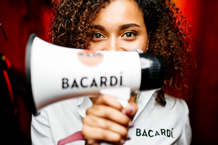 Fashion photo of beautiful waitress in a bar with horn in white shirt "BACARDI"のeditorial素材
