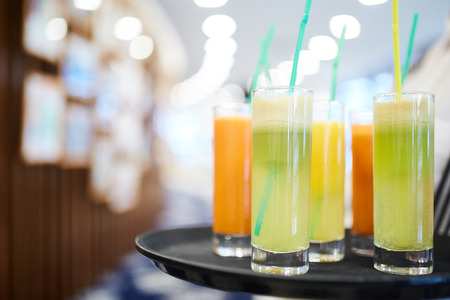 Great photo of different good cocktails with tubules on the black tray close-upの写真素材