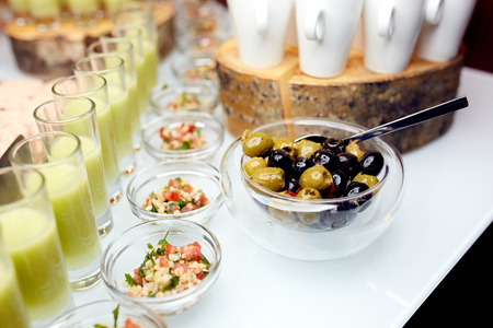 Great photo of interesting dishes in glass plates and olivesの写真素材