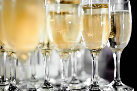 Close-up photo of wine glasses with champagne on the tableの写真素材