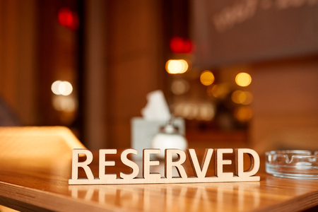 Close-up photo of "Reserved" the table on the blur backgroundの写真素材