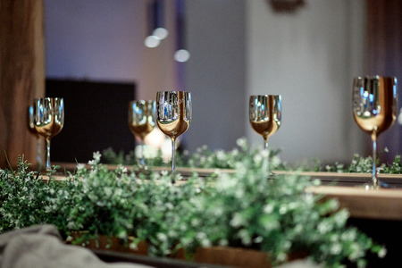 Great photo of amazing golden wine glasses " Moet and Chandon" on the white tableの写真素材