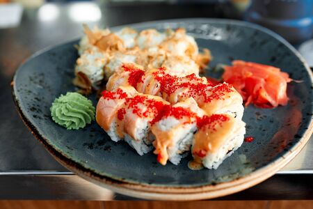 Great photo of sushi with fish on the red plateの写真素材