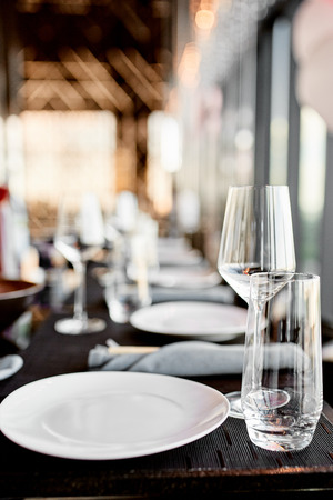 clean glass and plate on the table in a restaurant, serving devicesの写真素材