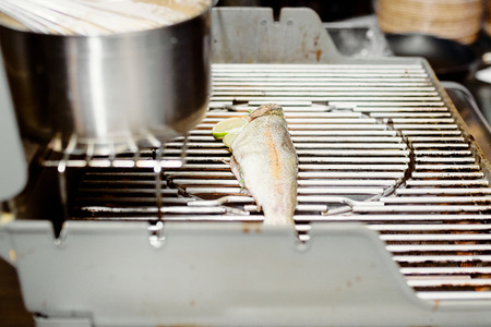 cleaned white fish with lime ready to stew next to the panの写真素材