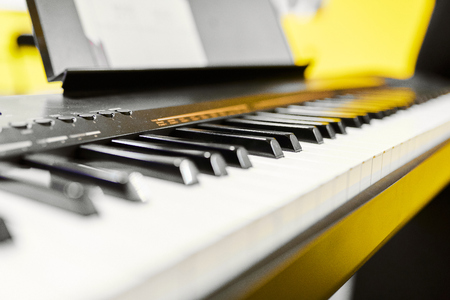 black and white synth keys on yellow background  with notesの写真素材