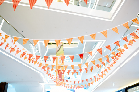 different colour decorative flags in the mall and the ceiling in the backgroundの写真素材