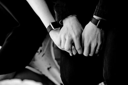 male hands hold female hand in black and white at the roomの写真素材