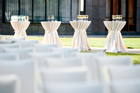 tables with drinks and champagne glasses in the open air at a weddingの写真素材