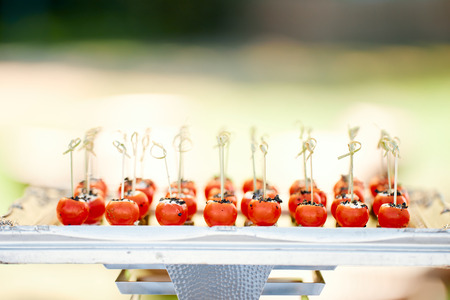 wedding dish of stuffed cherry tomatoes on a trayの写真素材