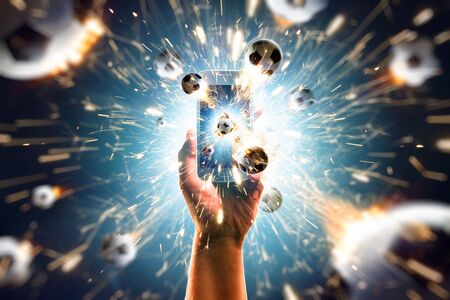 Soccer balls flies from the smartphoneの写真素材