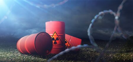 Barrels of toxins. Chemical pollution. Barbed wireの写真素材