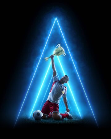 Soccer neon concept. Soccer player celebrate victory. Blue neon light. Isolatedの写真素材