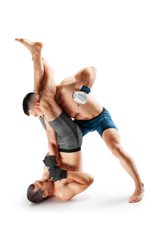 Two fighters are crazy fighting. punches. sport concept. Emotions of winner. isolated. MMA actionの写真素材