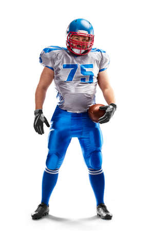 sport. An American football player stands and holds a ball in his hand. isolated on white background. Manの写真素材