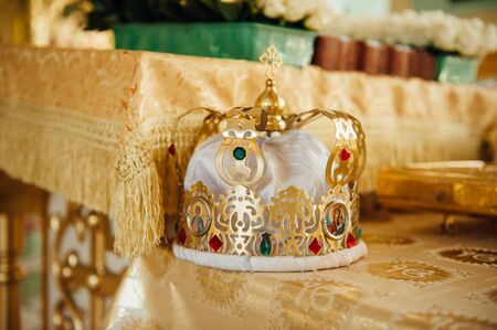 luxury golden crowns with stones for the wedding ceremony in the old church goldの写真素材