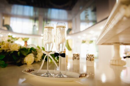 Wedding glasses filled with champagne at the banquetの写真素材