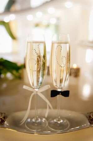 Wedding glasses filled with champagne at the banquetの写真素材