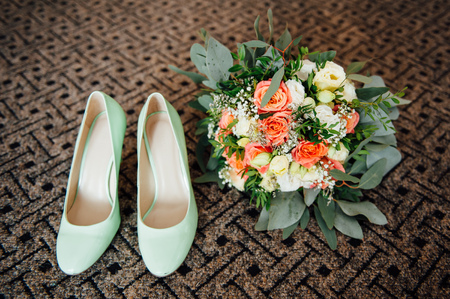 wedding bouquet and bridesmaid shoes on brown matの写真素材