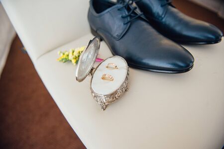 Set of groom clothes. Wedding rings, shoes, cufflinks and bow tie detalisの写真素材