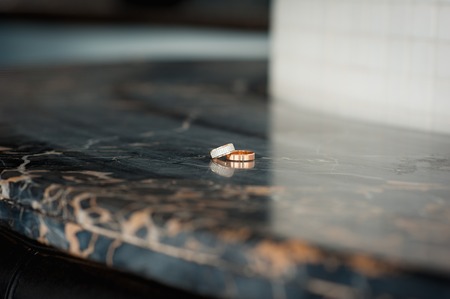 pair of  wedding rings with bokeh background granite plate