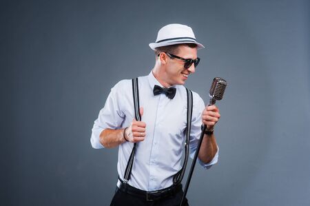portrait of a man with retro style microphone.の写真素材