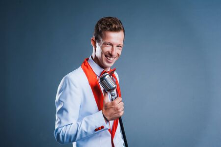 portrait of a man with retro style microphone.の写真素材