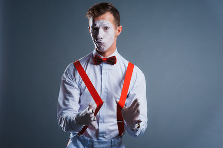 studio shot of two mimes isolated on gray backgroundの写真素材