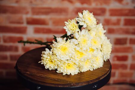 bouquet of chrysanthemums on a wooden plate.の写真素材