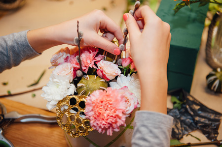 florist makes a basket with different flowers.の写真素材