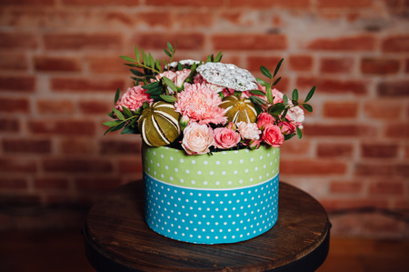 basket of spring flowers on a wooden chair. handmade.の写真素材
