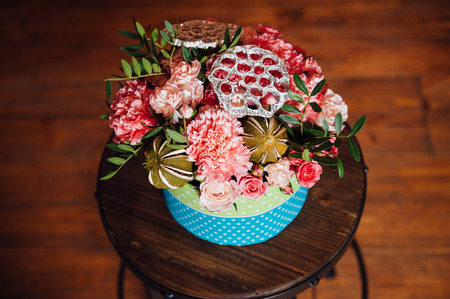 basket of spring flowers on a wooden chair. handmade.の写真素材