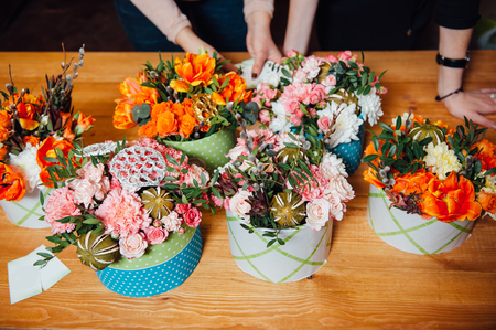 basket of spring flowers on a wooden chair. handmade.の写真素材