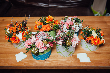 basket of spring flowers on a wooden chair. handmade.の写真素材