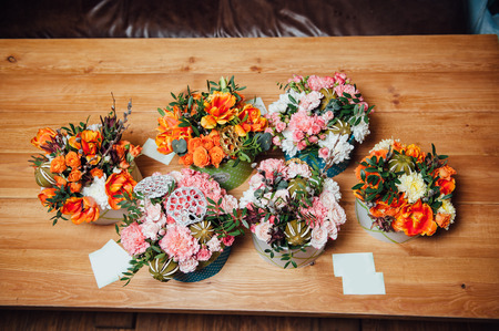 basket of spring flowers on a wooden chair. handmade.の写真素材
