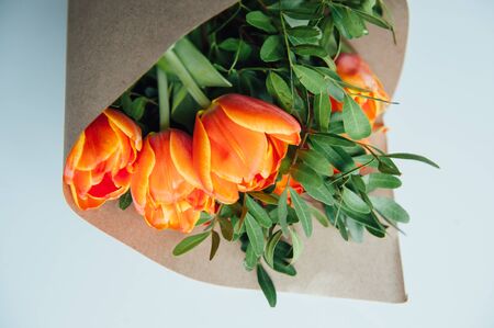 orange tulips packagedon a old wooden background.の写真素材