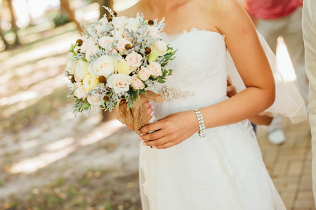 Beautiful wedding bouquet in hands of the bride.の写真素材