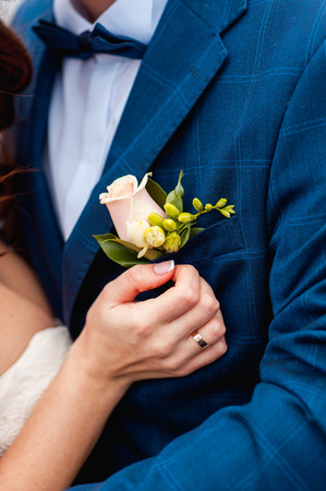 Bride and groom holding wedding bouquet together . Hug . beautiful hairの写真素材
