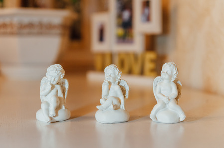 Angels family made of ceramics on a table.の写真素材