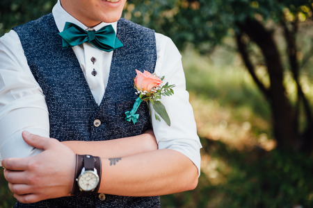 groom clasping stylish watch band on his wrist.の写真素材