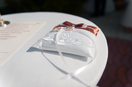 pair of  wedding rings with bokeh background paperの写真素材